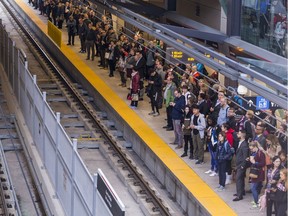 Commuters at the Tunney's Pasture Station await their train on Monday.