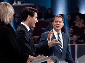 Justin Trudeau and Andrew Scheer argue a point as Elizabeth May listens during the Federal leaders debate in Gatineau, Que. on Oct. 7, 2019.