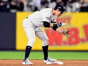 Yankees baserunner DJ LeMahieu celebrates after hitting a double to left field to score three runs against the Twins during the seventh inning in Game 1 of the American League Division Series at Yankee Stadium in New York City, on Friday, Oct. 4, 2019.