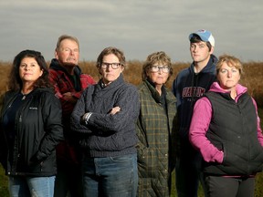 Ace Powell (red jacket) and his wife Michelle (far left), along with their neighbours (from left: Teddie Laframboise, Pat Gillis, Austin Hutt and Casey Gillis), stand at the end of Powell's property in North Gower, where a proposed massive warehouse/distribution centre is proposed.