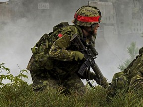 Simulated opposing forces attack a defensive position occupied by members of the Canadian Army Reserve, 4th Canadian Division, during Exercise STALWART GUARDIAN on August 26, 2015 at Garrison Petawawa, Ontario.