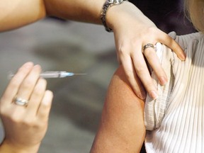 Files: A person gets a flu shot during a vaccine program