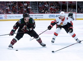 Files: Arizona Coyotes right-winger Conor Garland (83) skates with the puck against Ottawa Senator Vladislav Namestnikov (90)