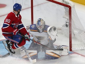 St. Louis Blues goaltender Jordan Binnington makes a save as Canadien' Tomas Tatar jumps at Bell Centre on Saturday, Oct. 12, 2019.