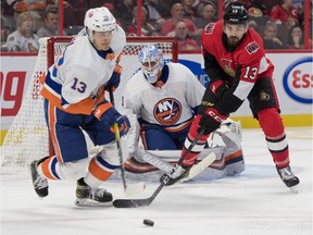 New York Islanders center Mathew Barzal (13) battles for the puck with Ottawa Senators left wing Nick Paul (13) in the second period at the Canadian Tire Centre.