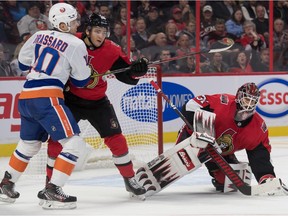 Senators defenceman Erik Brannstrom, shown here shielding Islanders centre Derick Brassard in front of goalie Anders Nilsson in a game on Oct. 25, played less than eight minutes in Sunday's game against the Sharks.
