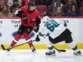 Senators defenceman Thomas Chabot shoots the puck past Sharks centre Melker Karlsson (68) in the second period of Sunday's game in Ottawa.