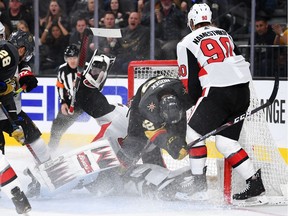 The Vegas Golden Knights' Tomas Nosek collides with Ottawa Senators goaltender Anders Nilsson during the second period at T-Mobile Arena on Thursday, Oct. 17, 2019.