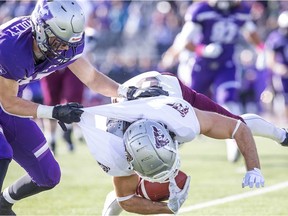 Western's Zach Lindley was assessed a major penalty for this horse-collar tackle on the Gee-Gees Dylan St. Pierre during Saturday's game in London, Ont.