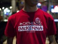 Supporter of Liberal candidate Catherine McKenna wears the campaign shirt and badge.