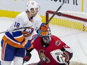 Ottawa Senators goaltender Anders Nilsson gets a little help from his goal post as New York Islander Anthony Beauvillier looks for a rebound during NHL action at the Canadian Tire Centre in Ottawa on Friday October 25, 2019. Errol McGihon/Postmedia