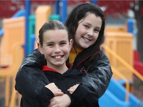 Juliet Murphy (right) and Darcy Power pose for a photo at Furness Park in Ottawa on Tuesday. Juliet and Darcy found a 60-year-old man who'd suffered a cardiac arrest at Amarillo Drive and Lydia Way, in Barrhaven Saturday and got help.