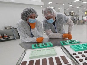 Hummingbird Chocolate owners Erica and Drew Gilmour pose with some products at Canopy Growth Corp. in Smiths Falls on Wednesday, Oct. 16, 2019.
