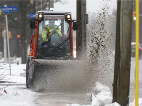 Ottawa city crews clear sidewalks after a 2018 storm.