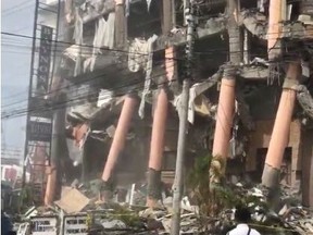 A man looks at a damaged hotel building after an earthquake in Kidapawan City, Cotabato, Philippines, October 31, 2019, in this still image obtained from a social media video.