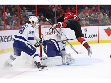 Scott Sabourin is called for goalie interference as he flies over top of Curtis McElhenney in the first period as the Ottawa Senators take on the Tampa Bay Lightning in NHL action at the Canadian Tire Centre. Photo by Wayne Cuddington / Postmedia