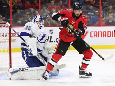 Artem Anisimov tries to deflect the puck past goalie Curtis McElhinney in the first period as the Ottawa Senators take on the Tampa Bay Lightning in NHL action at the Canadian Tire Centre. Anisimov left the game with an injury. Photo by Wayne Cuddington / Postmedia