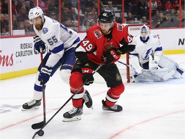 Scott Sabourin battles with Braydon Coburn as goalie Curtis McElhinney looks on in the first period as the Ottawa Senators take on the Tampa Bay Lightning in NHL action at the Canadian Tire Centre. Photo by Wayne Cuddington / Postmedia