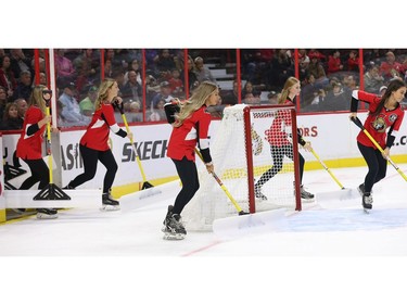 The team of snow shovellers come out during a time out in the first period as the Ottawa Senators take on the Tampa Bay Lightning in NHL action at the Canadian Tire Centre. Photo by Wayne Cuddington / Postmedia