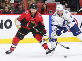 Senators’ Chris Tierney and Steven Stamkos of the Tampa Bay Lightning battle for the puck during the first period  on Saturday in Ottawa. (WAYNE CUDDINGTON/POSTMEDIA NETWORK)