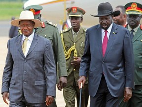 Uganda's President Yoweri Museveni, left, is received by South Sudan's President Salva Kiir, right, at the Juba international airport, in Juba, South Sudan, on Oct. 14, 2019.