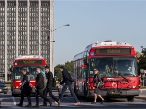 Files: OC Transpo buses depart Tunney's Pasture station with passengers headed east after a door malfunction caused delays with the LRT system on Oct. 9, 2019.