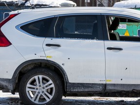 A scene on Bayswater Avenue where a suv sits with several bullet holes visible on the passenger side. November 13, 2019.