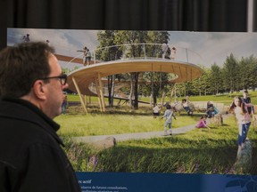A member of the public scans one of the conceptual drawings for the new LeBreton Flats at an NCC open house this past week.
