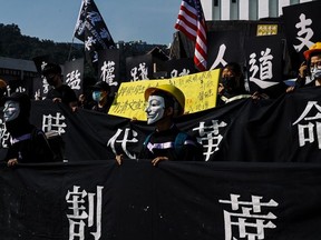 Students in Guy Fawkes masks march before the congregation ceremony at the Chinese University of Hong Kong on November 7, 2019 in Hong Kong, China.