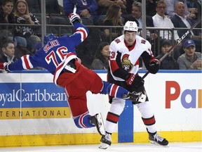 Nick Paul of the Senators knocks Brady Skjei of the Rangers to the ice with a check in the first period of Monday's game at Madison Square Garden in New York.