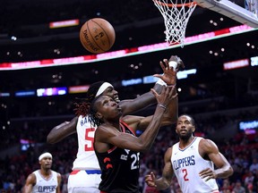 Chris Boucher of the Raptors and Montrezl Harrell of the Clippers battle for a rebound during Monday's game in Los Angeles. The Clippers won 98-88.