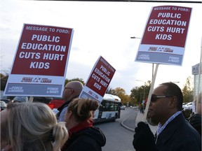 Protesters hold up their signs on Merivale Road in October 2019.