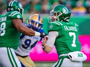 Saskatchewan Roughriders quarterback Cody Fajardo, right, looks to pass against the Winnipeg Blue Bombers in the first half during the CFL Western Conference Final football game at Mosaic Stadium, Nov. 17, 2019.