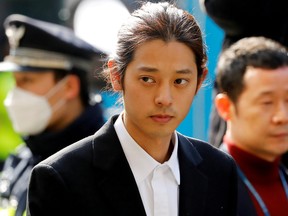 South Korean singer Jung Joon-young arrives for questioning on accusations of illicitly taping and sharing sex videos on social media, at the Seoul Metropolitan Police Agency in Seoul, South Korea, March 14, 2019. (REUTERS/Kim Hong-Ji/File Photo)