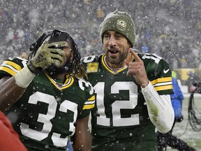 Aaron Rodgers (right) and Aaron Jones will be a lot warmer this Sunday when the Packers visit the 49ers. (GETTY IMAGES)