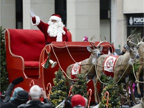File photo/ Santa Claus waves at the crowd and remind children.