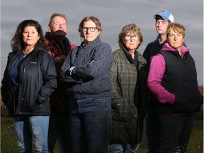 Ace Powell (red jacket) and his wife Michelle (far left), along with their neighbours (from left: Teddie Laframboise, Pat Gillis, Austin Hutt and Casey Gillis) stand at the end of Powell's property in North Gower, where a proposed massive warehouse/distribution centre will be built.