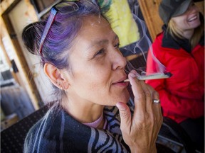 Sherry Kohoko owns Madashk, a cannabis shop in the community of Pikwàkanagàn First Nation, near Golden Lake. Kohoko has been given the go-ahead by the Alcohol and Gaming Commission of Ontario to apply for a licence to run a legal cannabis store at her property, which is now home of Madashk dispensary. Kohoko smokes a joint outside her shop Saturday afternoon.