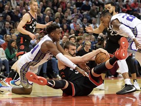 Raptors center Marc Gasol (33) battles for the ball with Sacremento Kings forward Buddy Hield (24) and guard Richaun Holmes (22) in the first half at Scotiabank Arena. Mandatory Credit: Dan Hamilton-USA TODAY Sports