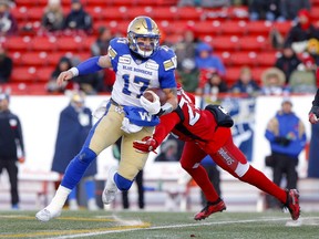 Calgary Stampeders, Jamar Wall tries to tackle Winnipeg Blue Bombers QB, Chris Streveler during the CFL semi-finals in Calgary on Sunday