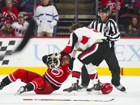 Senators right wing Bobby Ryan fights Carolina Hurricanes left wing Brock McGinn  during the first period at PNC Arena on Monday.