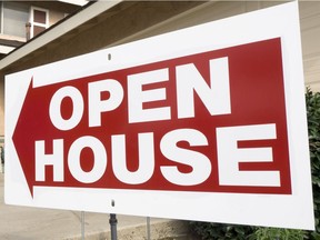 A home for sale shows the open house sign.