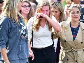 Grieving students from Saugus High School reunite with their parents in Santa Clarita, Calif., on Nov. 14, 2019. A teenage boy gunned down fellow students on his 16th birthday, killing two and wounding another three before turning the pistol on himself.