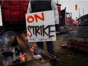 A Teamsters Canada union worker pickets at the Canadian National Railway at the CN Rail Brampton Intermodal Terminal after both parties failed to resolve contract issues, in Brampton, Ontario, Canada November 19, 2019.