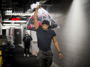 Quarterback Dominique Davis walks through the hall at TD Place with a bag of gear before the Redblacks' season-ending media availability on Sunday.