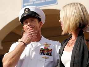 Special operations chief Edward Gallagher prepares to answer a question from the media with wife Andrea Gallagher after being acquitted on most of the serious charges against him during his court-martial trial at Naval Base San Diego in San Diego, Calif., July 2, 2019.