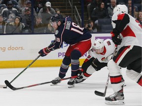 Senators forward Mikkel Boedker tries to poke the puck away from Blue Jackets centre Pierre-Luc Dubois during the second period of Monday's contest.