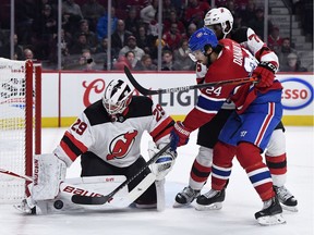 New Jersey Devils goalie Mackenzie Blackwood stops Montreal Canadiens forward Phillip Danault with the help of teammate P.K. Subban during the first period at the Bell Centre.