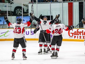 Carleton Ravens’ Jarod Steege (centre) celebrates with teammates after scoring the tying goal in the third period of Friday night’s fourth annual Colonel By Classic against the Ottawa Gee-Gees. Kody McDonald notched the game-winner as the Ravens added an empty-net goal. (Valerie Wutti/Carleton Athletics)