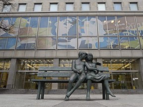 A statue sits at the entrance of a Library and Archives Canada building in Ottawa on Nov. 25, 2014.